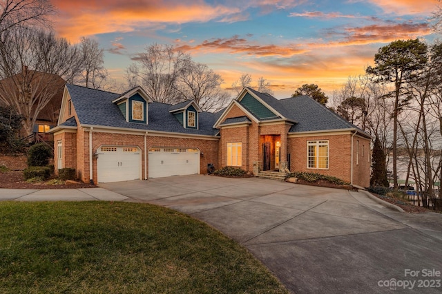 view of front of property featuring a yard and a garage