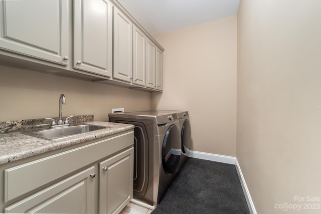 washroom featuring light carpet, hookup for a washing machine, sink, independent washer and dryer, and cabinets