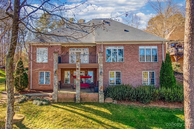 exterior space featuring a balcony and a front lawn