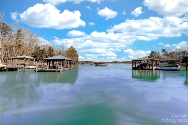 view of dock featuring a gazebo and a water view