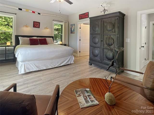 bedroom with ceiling fan and light wood-type flooring