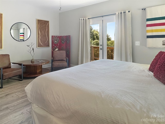 bedroom featuring french doors, light wood-type flooring, and access to outside