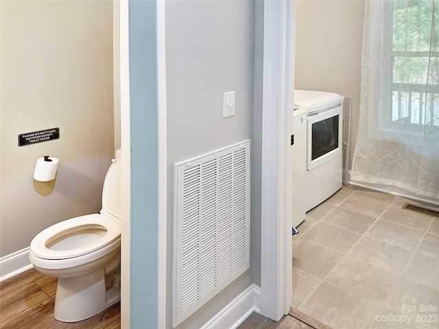 bathroom featuring tile floors, toilet, separate washer and dryer, and vanity