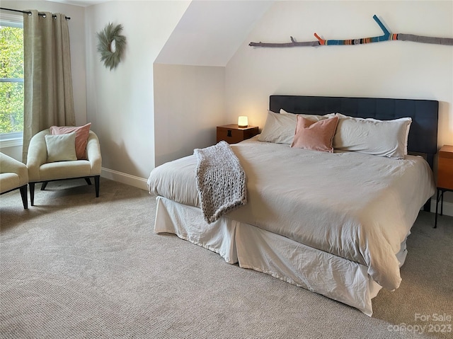 carpeted bedroom featuring vaulted ceiling