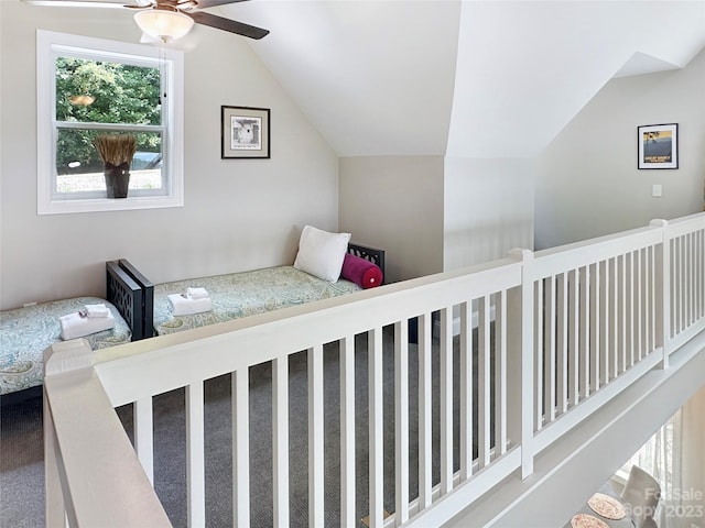 carpeted bedroom with vaulted ceiling and ceiling fan