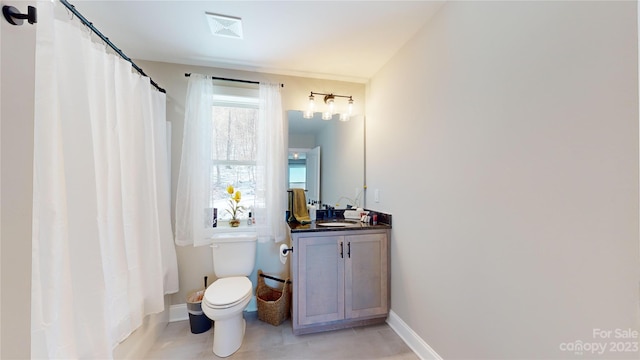 bathroom featuring toilet, tile floors, and vanity