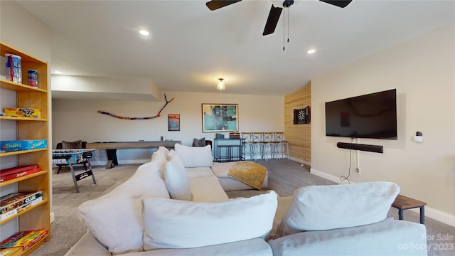 carpeted living room featuring ceiling fan