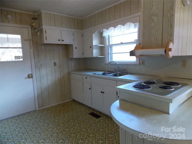 kitchen featuring tile flooring, white cabinets, sink, white electric cooktop, and ornamental molding