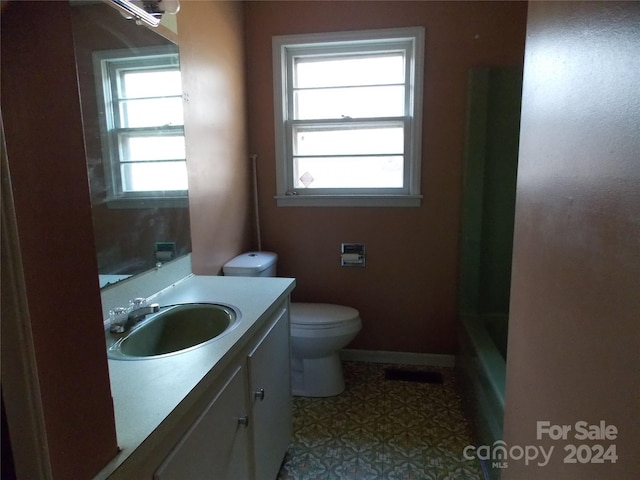 full bathroom featuring a wealth of natural light, vanity, tile floors, and toilet