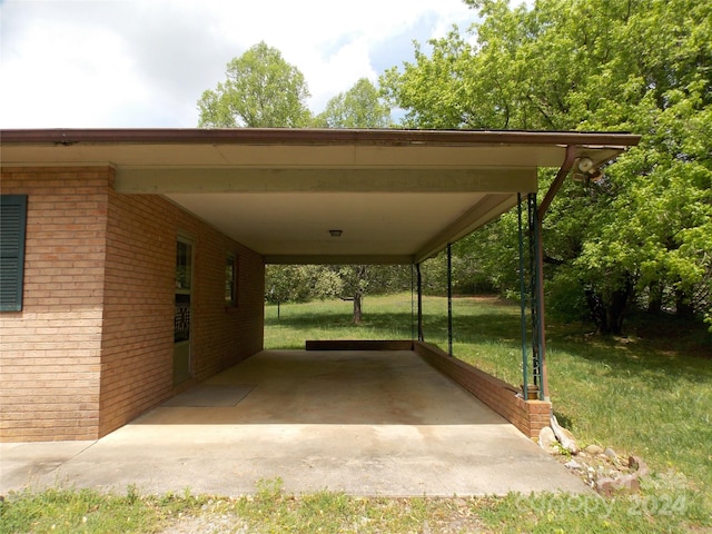 view of parking featuring a yard and a carport