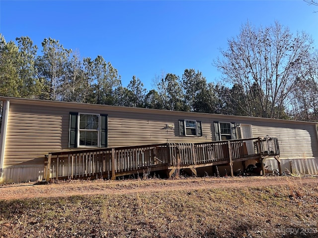 rear view of property featuring a deck