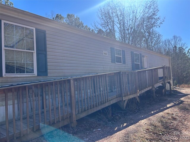 back of house with a wooden deck