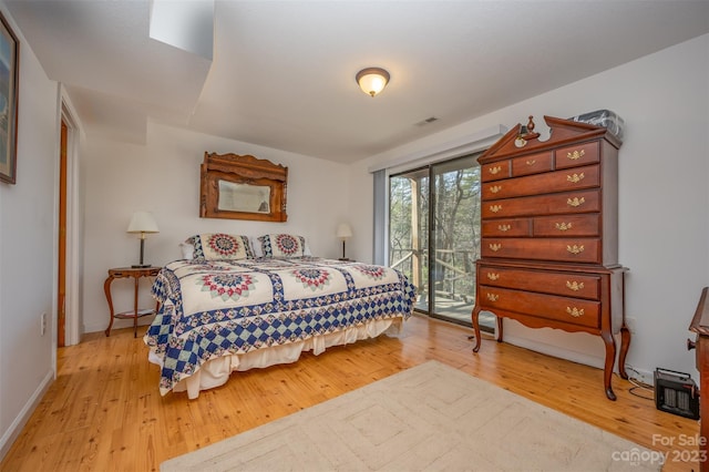 bedroom with access to outside and light wood-type flooring