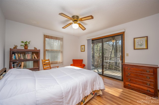 bedroom featuring a textured ceiling, ceiling fan, access to outside, and light wood-type flooring