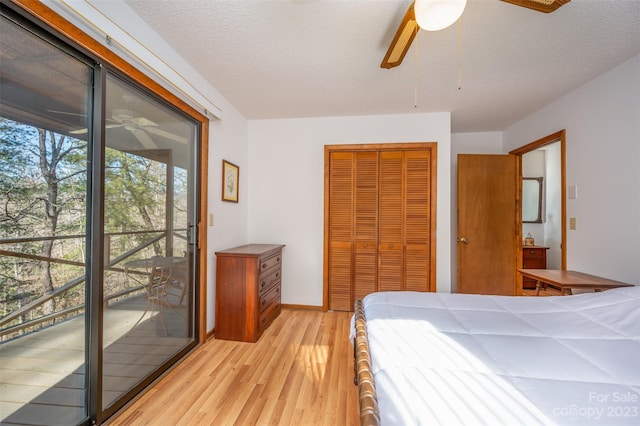 bedroom featuring light wood-type flooring, ceiling fan, access to exterior, and a closet