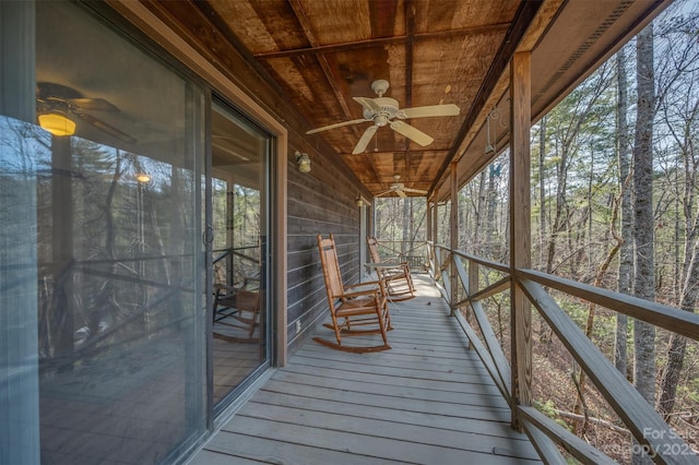 wooden deck featuring ceiling fan