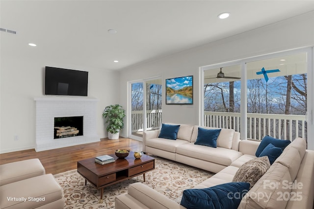 living room featuring hardwood / wood-style flooring and a fireplace