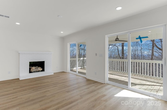 unfurnished living room featuring a fireplace and light wood-type flooring