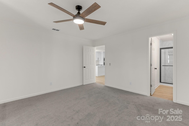 carpeted empty room with ornamental molding and ceiling fan