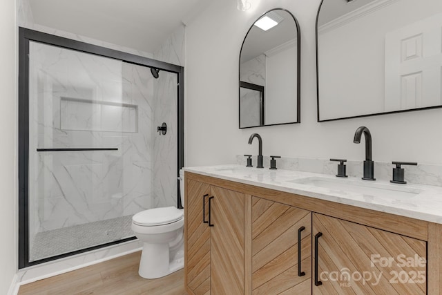 bathroom featuring walk in shower, toilet, ornamental molding, vanity, and hardwood / wood-style floors