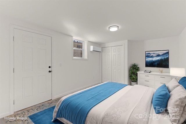 bedroom featuring a wall mounted AC, light wood-type flooring, and a closet