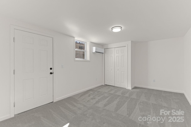 basement featuring light colored carpet and a wall unit AC