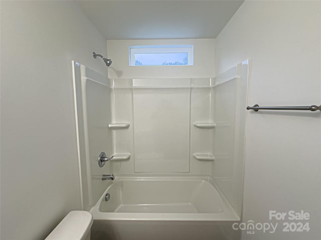 bathroom featuring shower / bathing tub combination and toilet