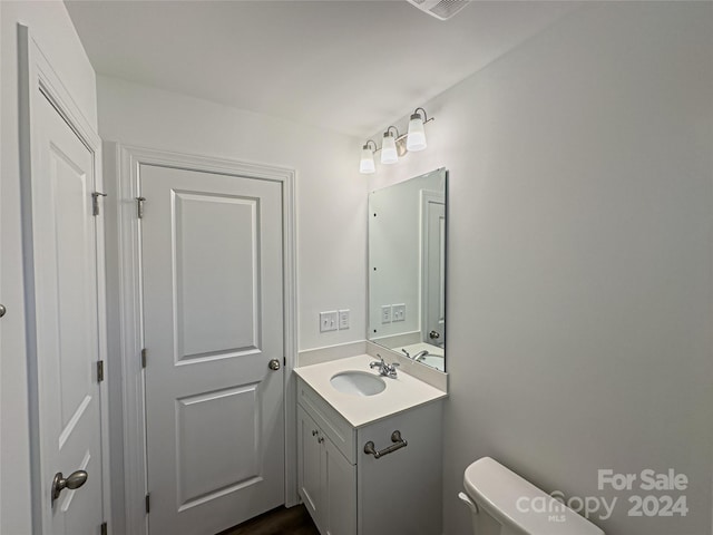 bathroom featuring oversized vanity and toilet