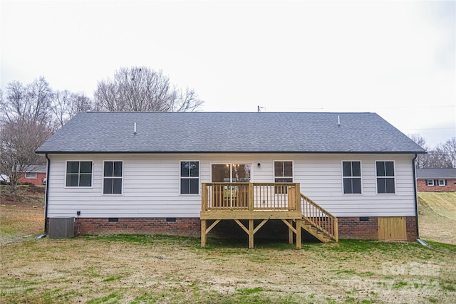 back of property featuring a deck, central air condition unit, and a lawn