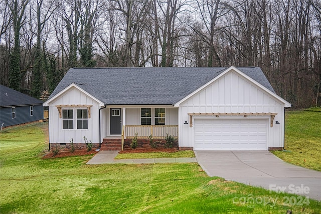 ranch-style house featuring a front yard and a garage