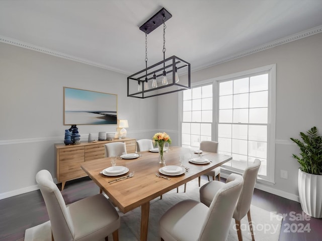 dining area with a notable chandelier, crown molding, and dark hardwood / wood-style floors