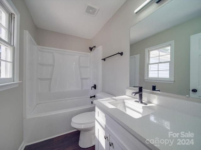 full bathroom with toilet, bathing tub / shower combination, large vanity, and hardwood / wood-style flooring