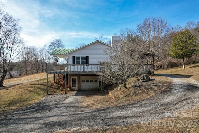 view of property featuring a front lawn and a garage