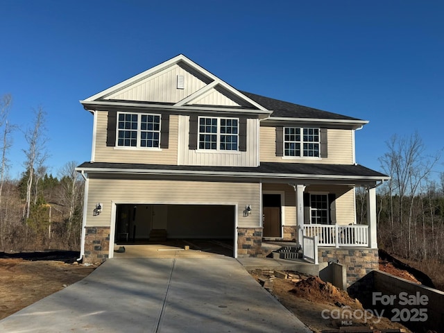 craftsman inspired home featuring a porch and a garage