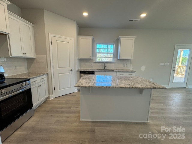 kitchen with white cabinetry, sink, and stainless steel appliances