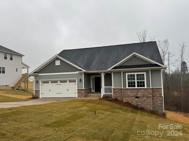 craftsman-style home featuring a porch, a garage, and a front yard