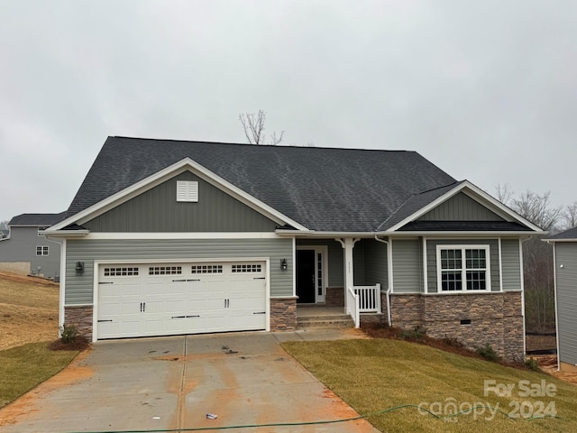 craftsman-style home with a front yard and a garage