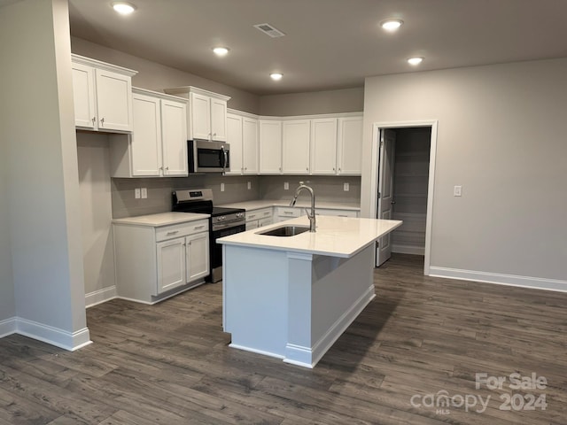 kitchen featuring white cabinetry, sink, dark hardwood / wood-style floors, a center island with sink, and appliances with stainless steel finishes