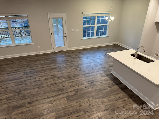 interior space featuring dark hardwood / wood-style flooring, sink, and a chandelier