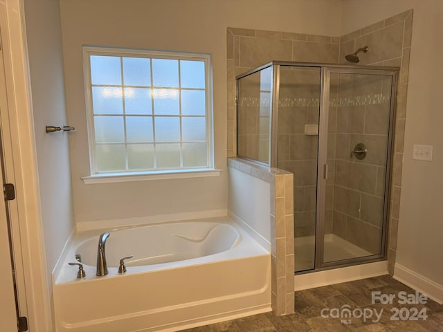 bathroom featuring plus walk in shower and a wealth of natural light