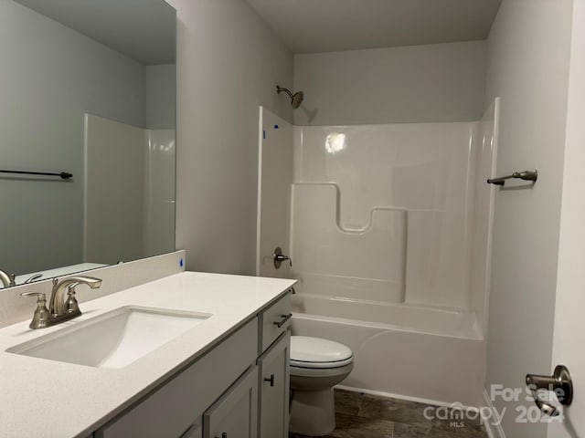 full bathroom featuring shower / bathing tub combination, vanity, and toilet