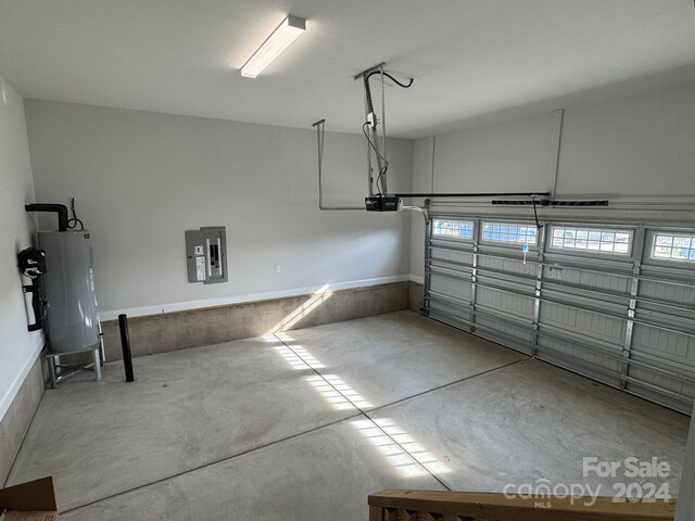 garage with electric panel, water heater, and a garage door opener