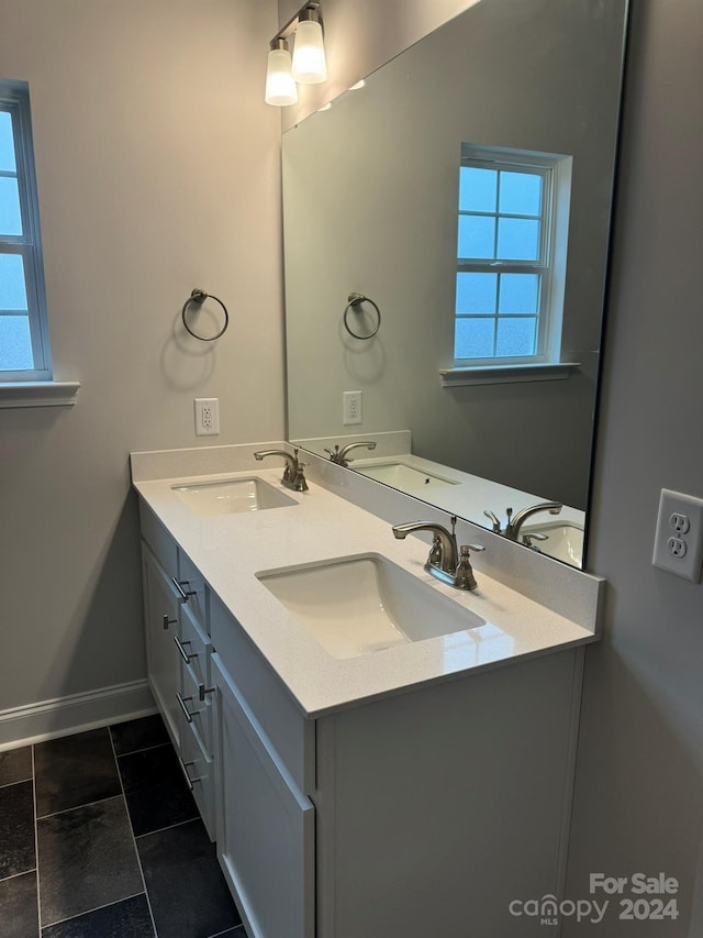 bathroom featuring tile patterned flooring and vanity