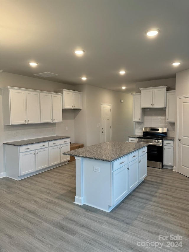 kitchen with a center island, light wood-type flooring, white cabinetry, and stainless steel range