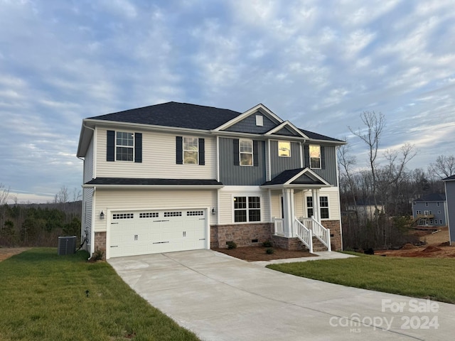 view of front of home featuring a front lawn, a garage, and cooling unit