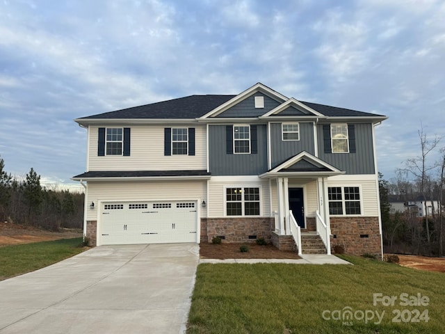 craftsman-style home featuring a front yard and a garage