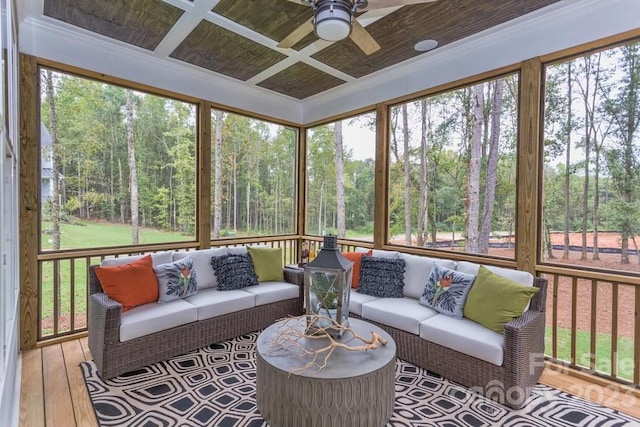 sunroom / solarium featuring a healthy amount of sunlight and ceiling fan