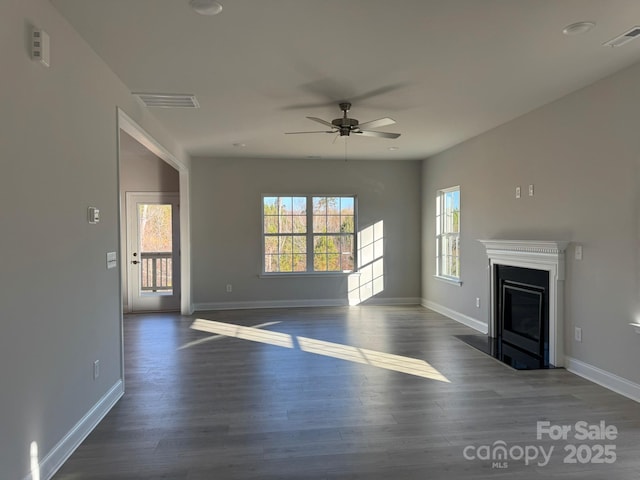 unfurnished living room featuring dark hardwood / wood-style floors and ceiling fan