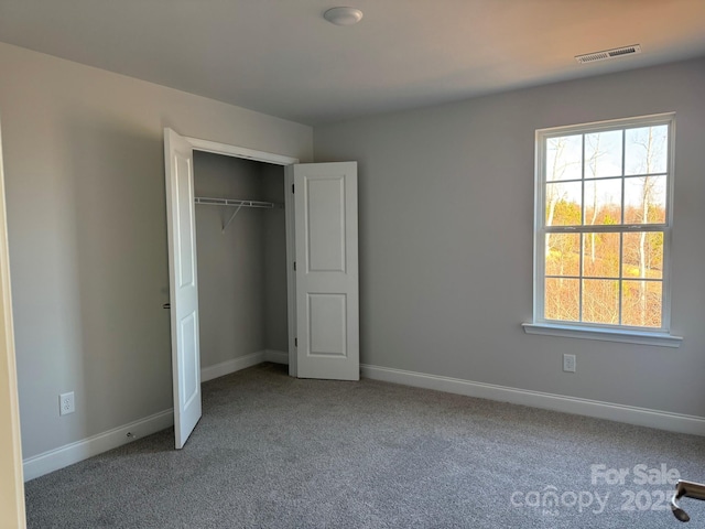 unfurnished bedroom with carpet floors and a closet