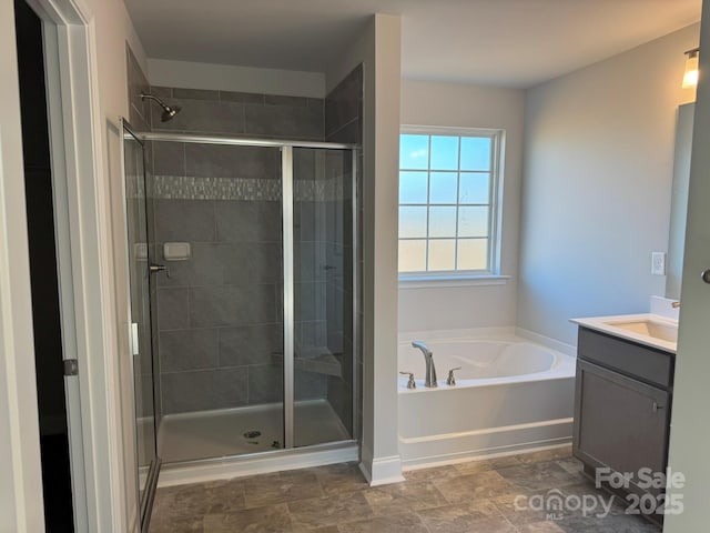 bathroom with vanity and shower with separate bathtub